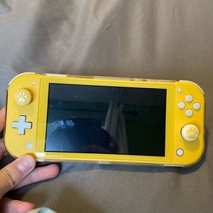 Yellow switch lite with thumb grips, case, and carrying case